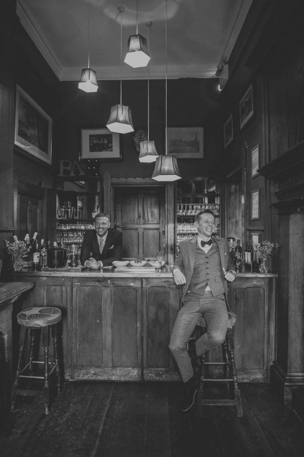 grooms laughing by Lucy Turnbull Photography