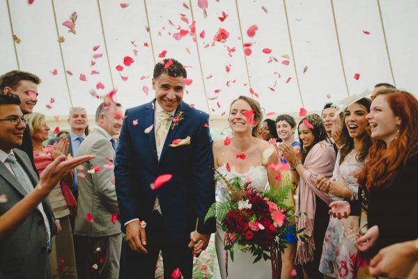 Bride groom and confetti by Keith Riley Photography