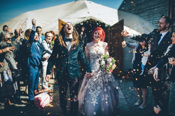 Bride and groom and confetti by Toby Lowe Photography