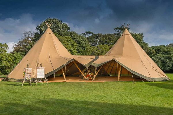 A wedding tipi tent in an open field from The Cornish Tent Co. as featured on eeek! weddings