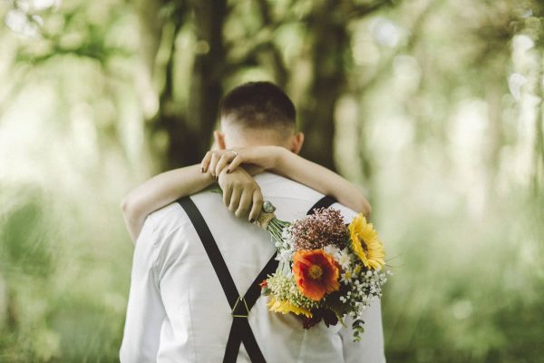 A photograph of a bride and groom holding one another by Ben Selway Photography