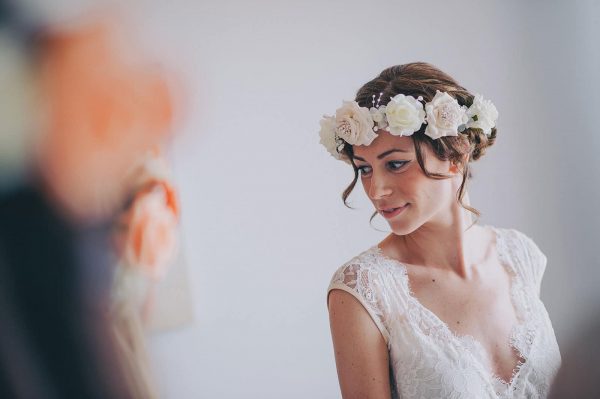Bride looking at herself in a mirror by Nick Walker Photography