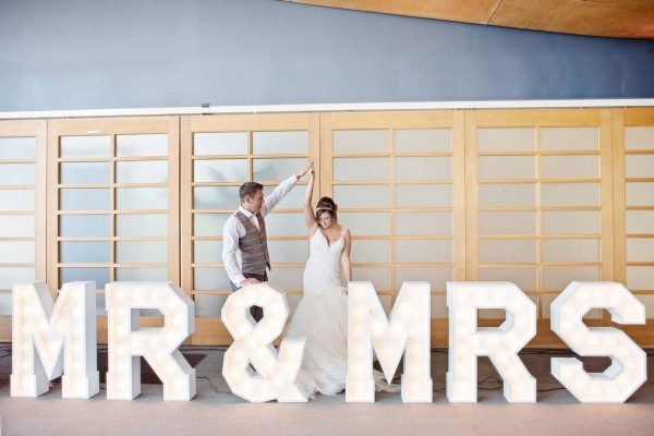 Newly weds dancing next to Mr and Mrs Letter Lights from Say it with Lights as featured on eeek! weddings