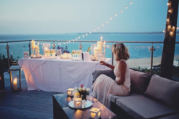 Bride sitting on a balcony looking out to sea at St Ives Harbour Hotel as featured on eeek! weddings