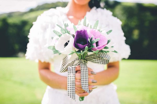 A bride holding beautiful handmade paper wedding flowers