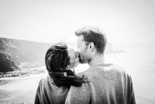 Newly engaged couple kissing on a beach by Verity Westcott Wedding Photographer