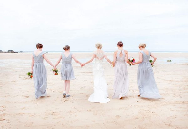 Bride and bridesmaids on a beach