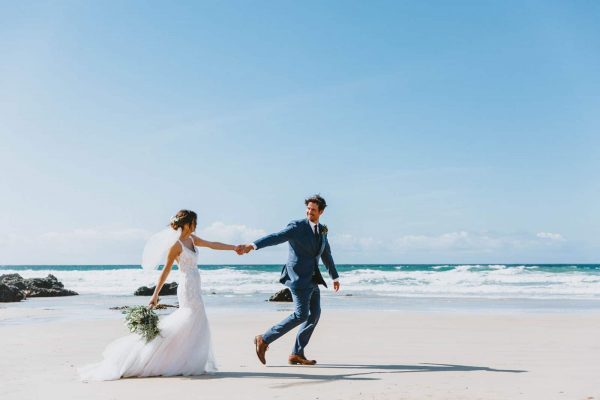 Bride and groom on a beach. Wedding photography by Wild Tide Creative