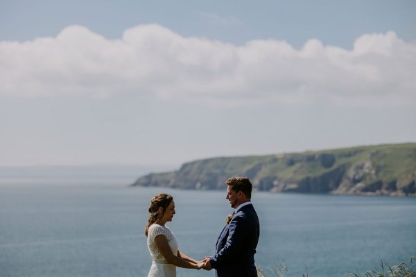 Overlooking the Cornish Coastline with bride and groom in the foreground - Get Married In Cornwall With eeek!